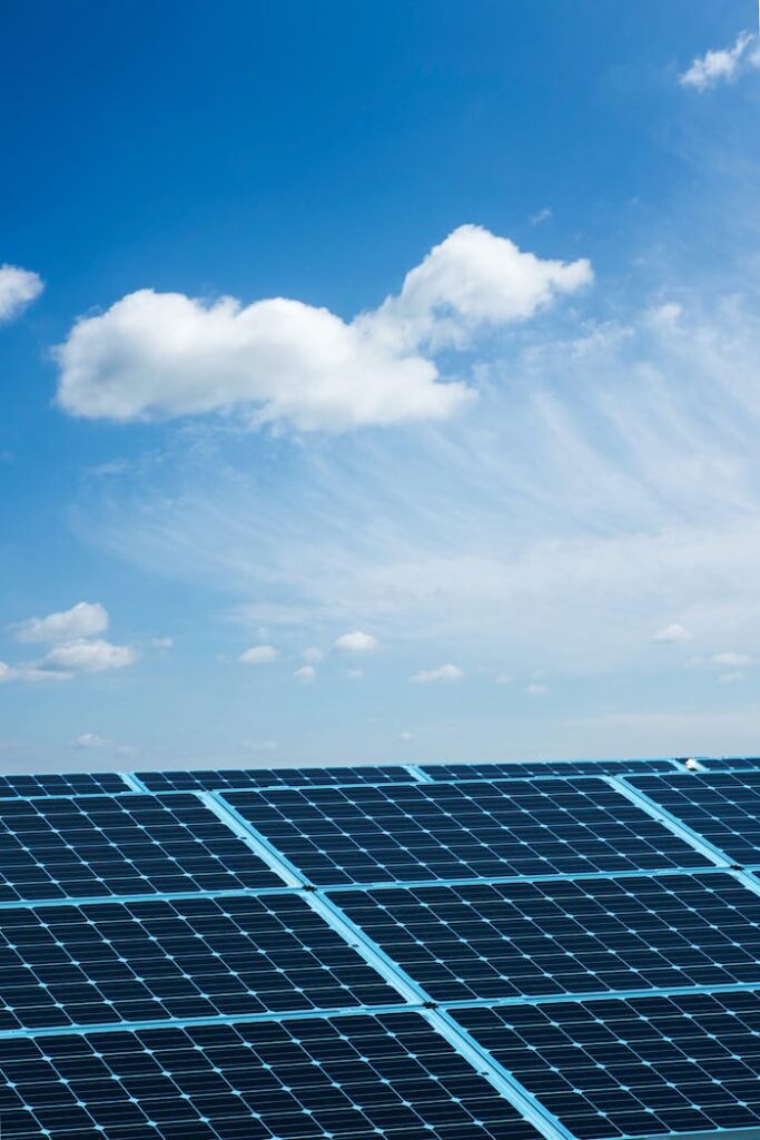 Solar panels under a clear blue sky, symbolizing renewable energy and sustainability.